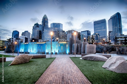 Narrow road in a park leading to downtown Charlotte city, with skyscrapers, North Carolina photo