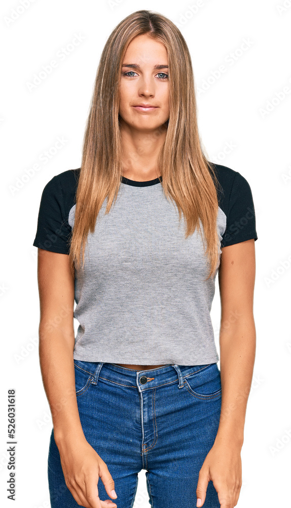 Obraz premium Young blonde woman wearing casual clothes relaxed with serious expression on face. simple and natural looking at the camera.