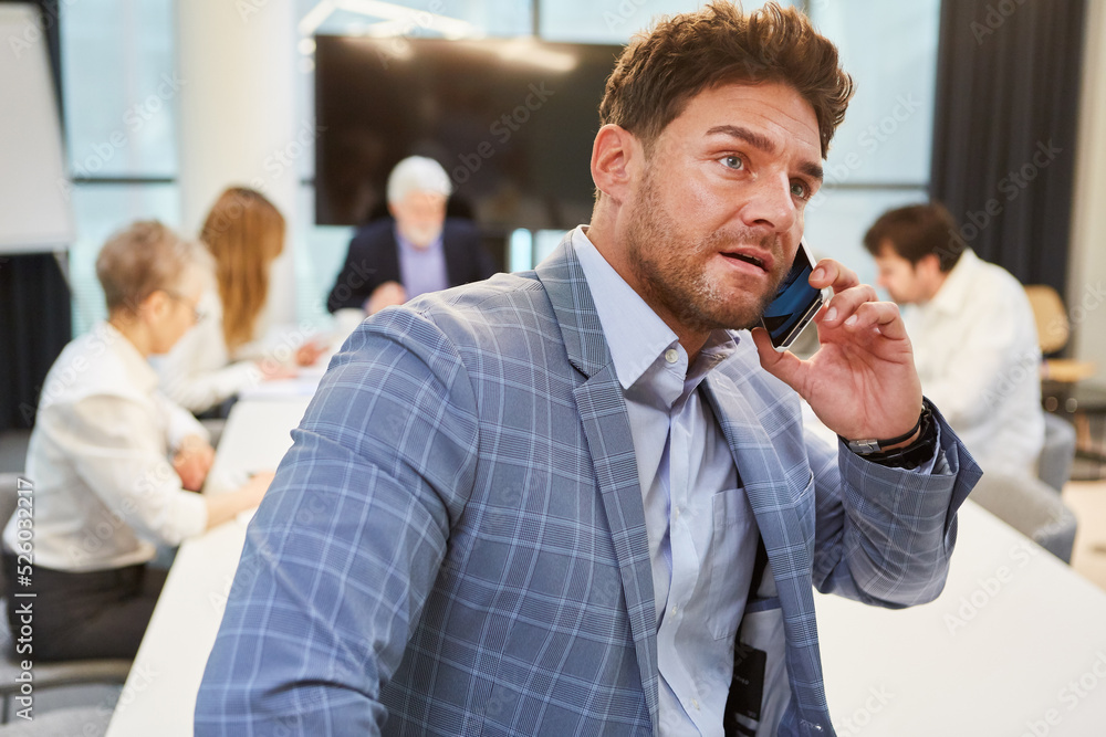 Stressed business man talking on smartphone Stressed business man talking on smartphone