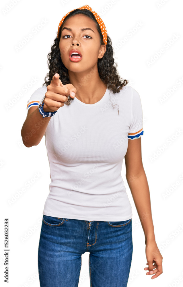 Young african american girl wearing casual clothes pointing displeased and frustrated to the camera, angry and furious with you Young african american girl wearing casual clothes pointing displeased and frustrated to the camera, angry and furious with you