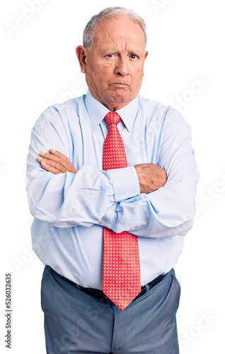 Senior handsome grey-haired man wearing elegant tie and shirt skeptic and nervous, disapproving expression on face with crossed arms. negative person.