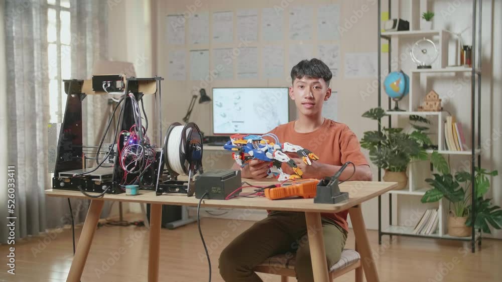 Smiling Asian Boy With A Cyborg Hand Showing Thumbs Up Gesture To The Camera While Working At Home
Smiling Asian Boy With A Cyborg Hand Showing Thumbs Up Gesture To The Camera While Working At Home