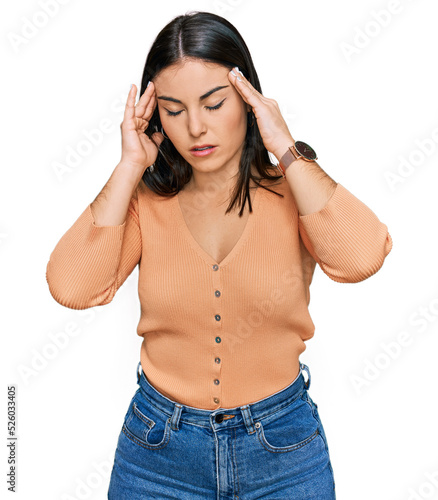 Young hispanic woman wearing casual clothes with hand on head, headache because stress. suffering migraine.