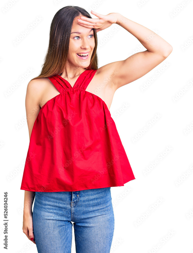 Fototapeta premium Beautiful brunette young woman wearing casual clothes very happy and smiling looking far away with hand over head. searching concept.