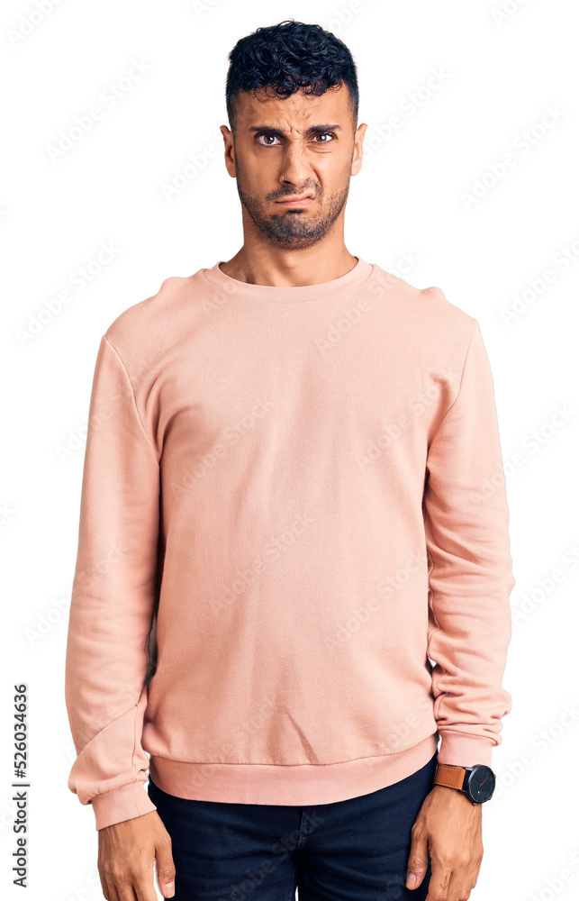 Young hispanic man wearing casual clothes skeptic and nervous, frowning upset because of problem. negative person. Young hispanic man wearing casual clothes skeptic and nervous, frowning upset because of problem. negative person.