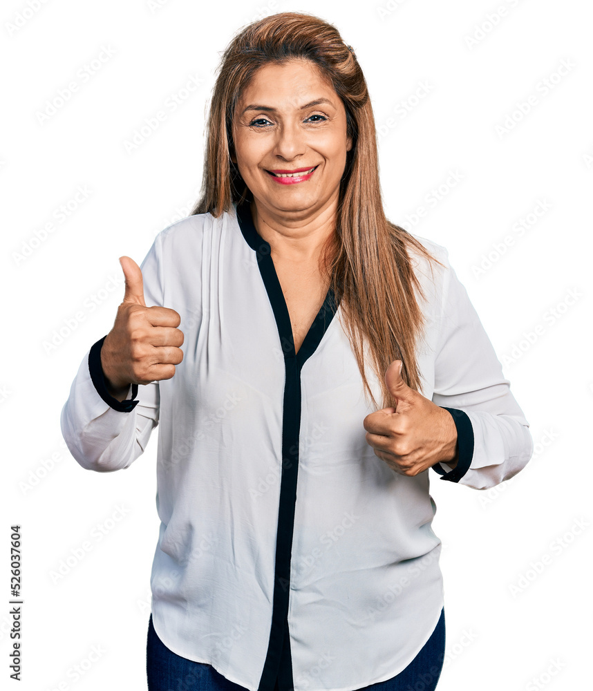 Middle age latin woman wearing business shirt success sign doing positive gesture with hand, thumbs up smiling and happy. cheerful expression and winner gesture. Middle age latin woman wearing business shirt success sign doing positive gesture with hand, thumbs up smiling and happy. cheerful expression and winner gesture.