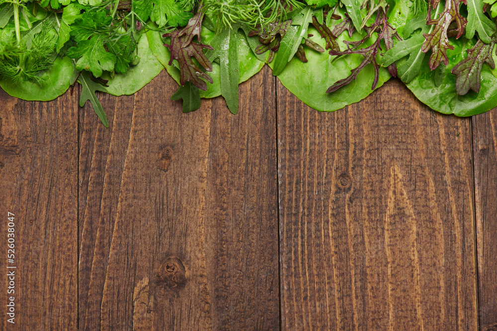 top view of green dill, parsley, salad, herbs and other greens on a dark wooden background, concept of fresh vegetables and healthy food, blank space or copy space for text top view of green dill, parsley, salad, herbs and other greens on a dark wooden background, concept of fresh vegetables and healthy food, blank space or copy space for text