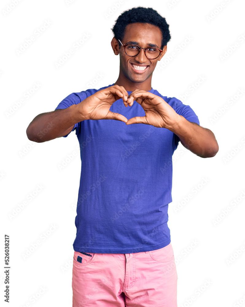 African handsome man wearing casual clothes and glasses smiling in love doing heart symbol shape with hands. romantic concept. African handsome man wearing casual clothes and glasses smiling in love doing heart symbol shape with hands. romantic concept.
