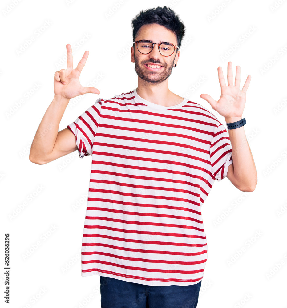 Young hispanic man wearing casual clothes showing and pointing up with fingers number eight while smiling confident and happy. Young hispanic man wearing casual clothes showing and pointing up with fingers number eight while smiling confident and happy.