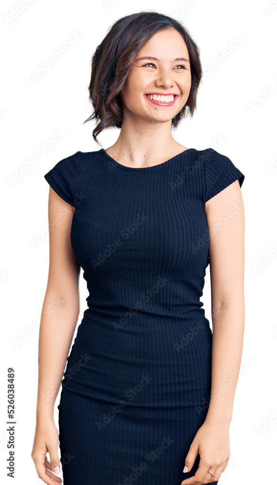 Young beautiful girl wearing casual clothes looking away to side with smile on face, natural expression. laughing confident. Young beautiful girl wearing casual clothes looking away to side with smile on face, natural expression. laughing confident.