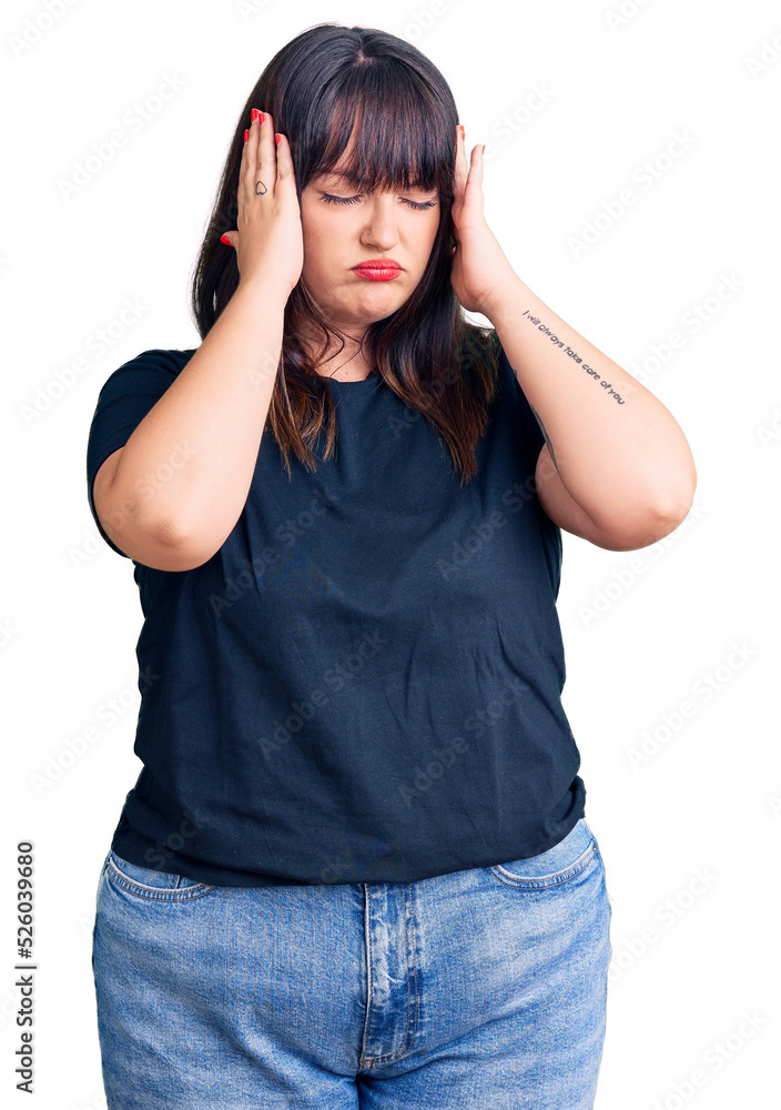 Young plus size woman wearing casual clothes suffering from headache desperate and stressed because pain and migraine. hands on head. Young plus size woman wearing casual clothes suffering from headache desperate and stressed because pain and migraine. hands on head.