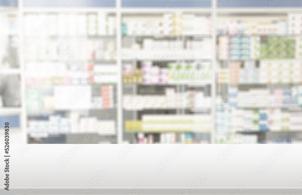 Empty white counter top with blur pharmacy drugstore shelves background Empty white counter top with blur pharmacy drugstore shelves background