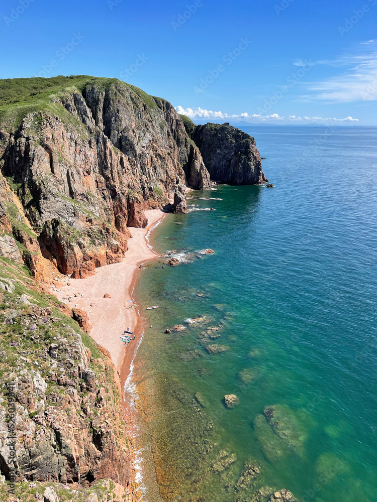 Fototapeta premium Russia, Vladivostok. The south-eastern coast of the island of Shkota in summer in clear weather