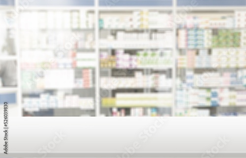 Empty white counter top with blur pharmacy drugstore shelves background