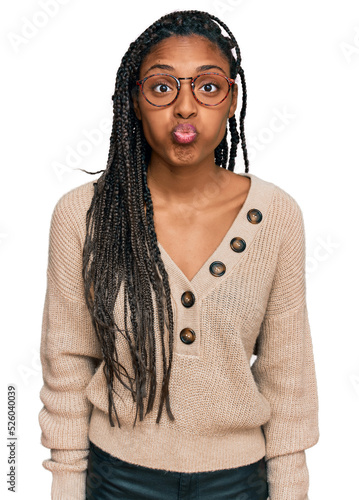 African american woman wearing casual clothes puffing cheeks with funny face. mouth inflated with air, crazy expression.
