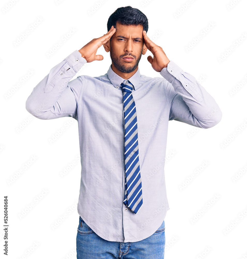 Young latin man wearing business clothes suffering from headache desperate and stressed because pain and migraine. hands on head. Young latin man wearing business clothes suffering from headache desperate and stressed because pain and migraine. hands on head.