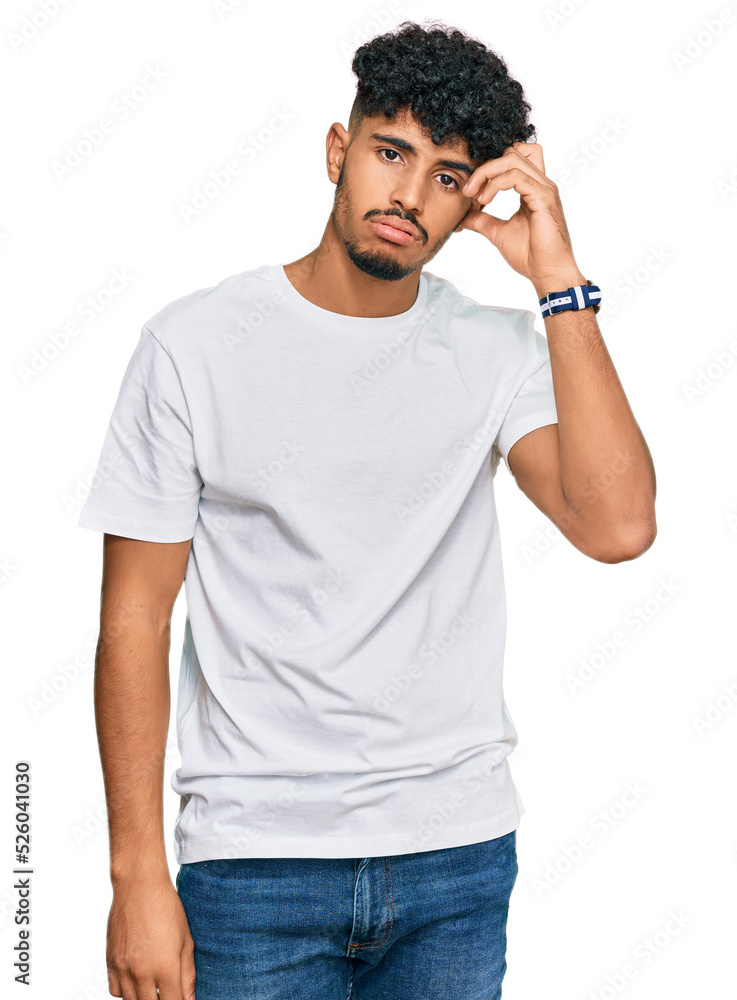 Young arab man wearing casual white t shirt worried and stressed about a problem with hand on forehead, nervous and anxious for crisis Young arab man wearing casual white t shirt worried and stressed about a problem with hand on forehead, nervous and anxious for crisis
