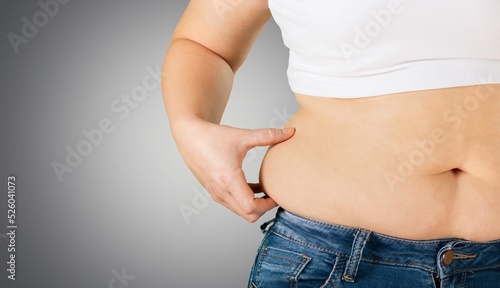 Obese woman against light background. Weight loss surgery concept © BillionPhotos.com
