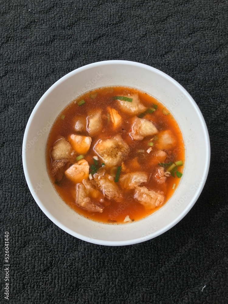 a serving of meatballs typical of Malang, East Java Indonesia. Isolated On a dark background