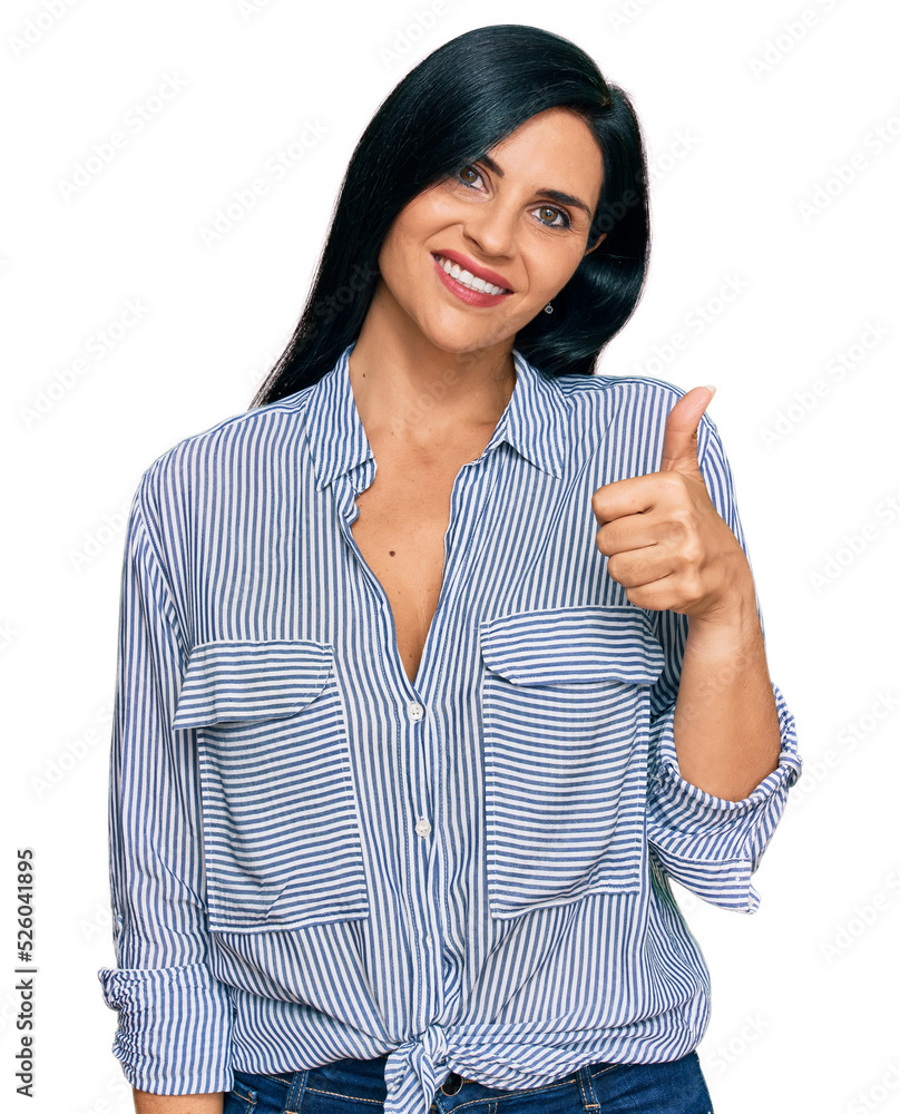 Young caucasian woman wearing casual clothes doing happy thumbs up gesture with hand. approving expression looking at the camera showing success. Young caucasian woman wearing casual clothes doing happy thumbs up gesture with hand. approving expression looking at the camera showing success.