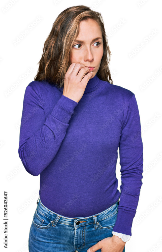 Young blonde woman wearing casual clothes looking stressed and nervous with hands on mouth biting nails. anxiety problem. Young blonde woman wearing casual clothes looking stressed and nervous with hands on mouth biting nails. anxiety problem.