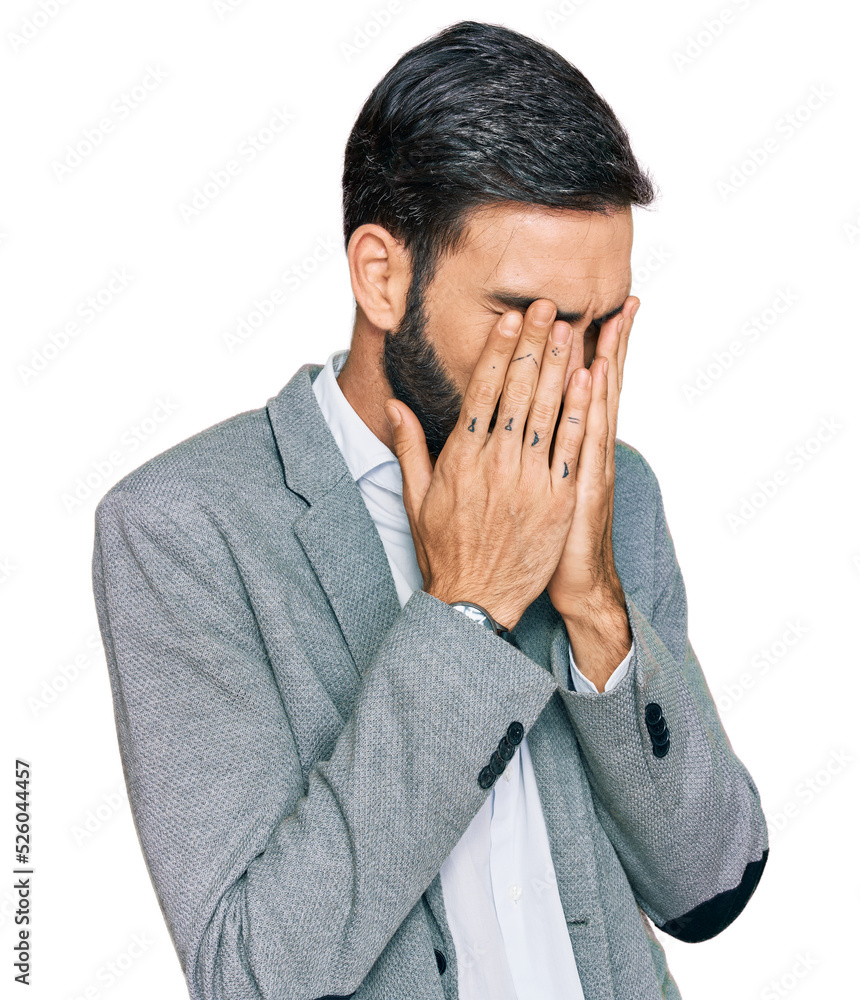 Young hispanic man wearing business clothes with sad expression covering face with hands while crying. depression concept. Young hispanic man wearing business clothes with sad expression covering face with hands while crying. depression concept.