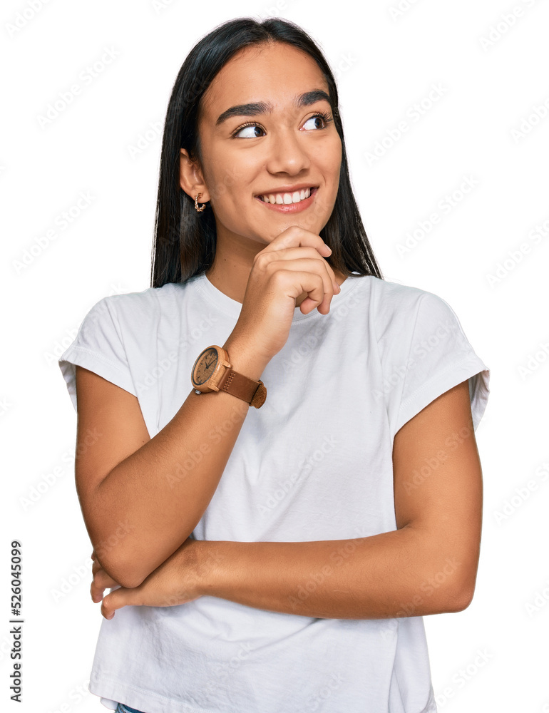 Young asian woman wearing casual white t shirt with hand on chin thinking about question, pensive expression. smiling with thoughtful face. doubt concept. Young asian woman wearing casual white t shirt with hand on chin thinking about question, pensive expression. smiling with thoughtful face. doubt concept.