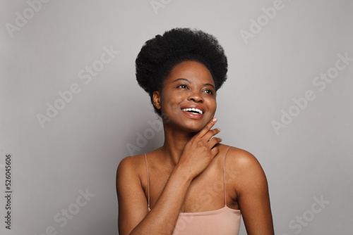  Beautiful happy woman with clean healthy skin and curly hair laughing and looking up