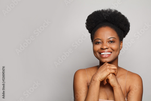  Cheerful young adult woman smiling and looking at camera