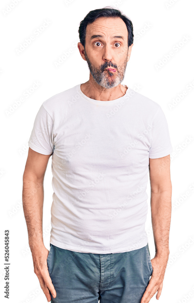 Middle age handsome man wearing casual t-shirt making fish face with lips, crazy and comical gesture. funny expression. Middle age handsome man wearing casual t-shirt making fish face with lips, crazy and comical gesture. funny expression.