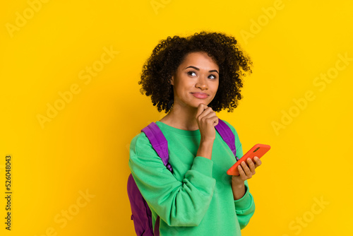 Portrait of charming minded lady hand touch chin look empty space isolated on yellow color background