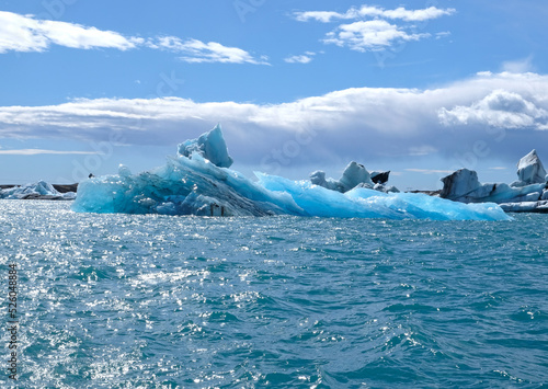Fotografie, Tablou A huge piece of translucent blue and turquoise ice is a beautiful iceberg that b
