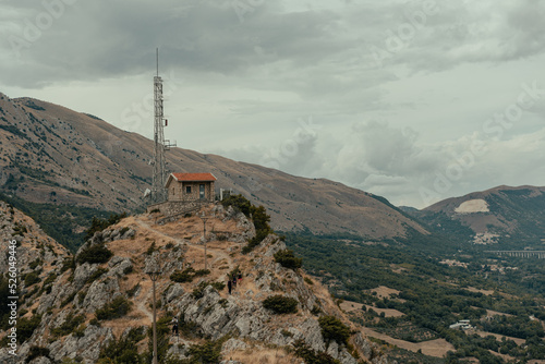 mountain house among the natural landscape with rock and overcast sky during a summer hike. © Raffaele Conti RC88