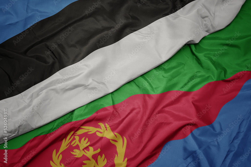 waving colorful flag of eritrea and national flag of estonia. waving colorful flag of eritrea and national flag of estonia.