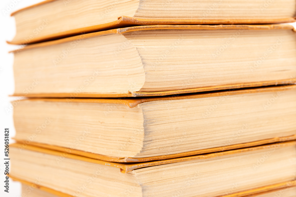 Stack of old books on light background. Book pile. Stack of old books on light background. Book pile.