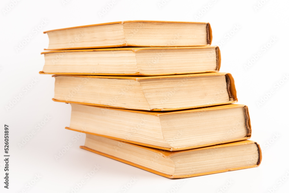 Stack of old books on light background. Book pile. Stack of old books on light background. Book pile.