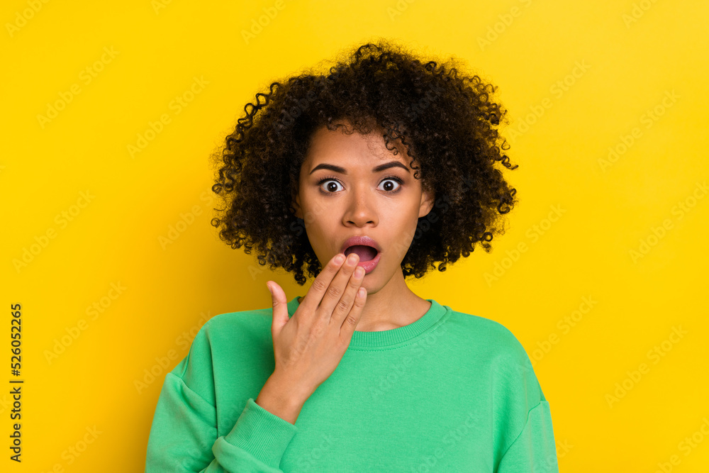 Photo of funny shocked young lady dressed green sweater arm cover open mouth isolated yellow color background Photo of funny shocked young lady dressed green sweater arm cover open mouth isolated yellow color background