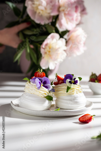 Sweet pavlova's dessert decorated with fresh strawberry and flowers © Татьяна Медведцкая