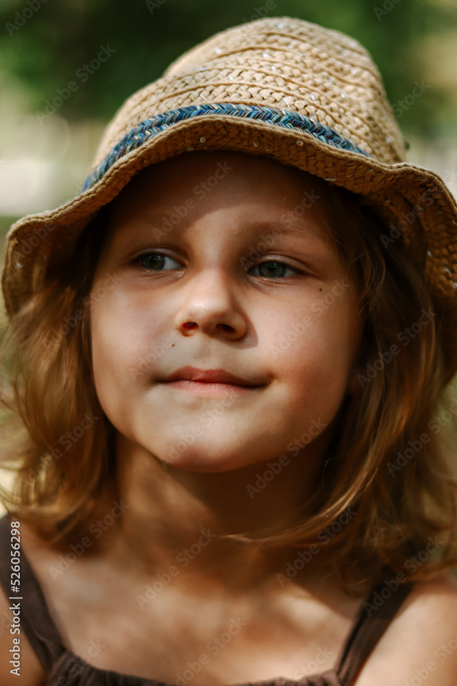 Cute blonde child 5 years old. Child in a straw hat. Portrait of a baby girl close-up. Cute blonde child 5 years old. Child in a straw hat. Portrait of a baby girl close-up.