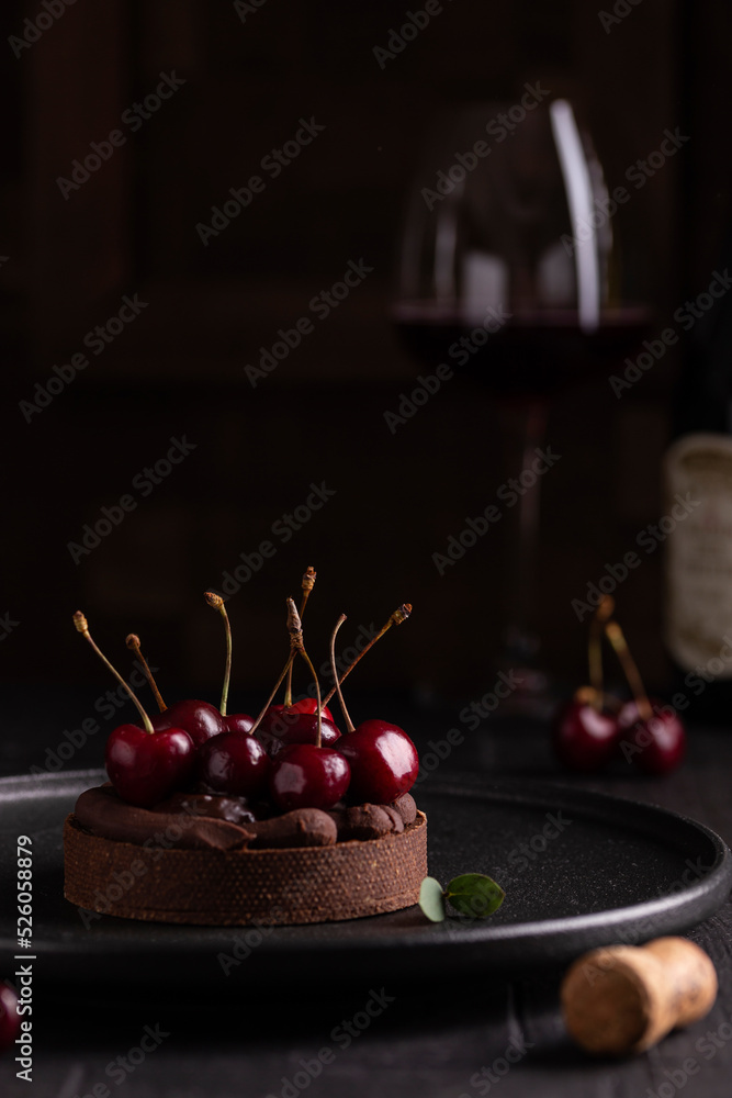 Chocolate tart with ganache decorated with cherry