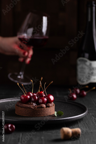 Chocolate dessert with berries and glass of wine