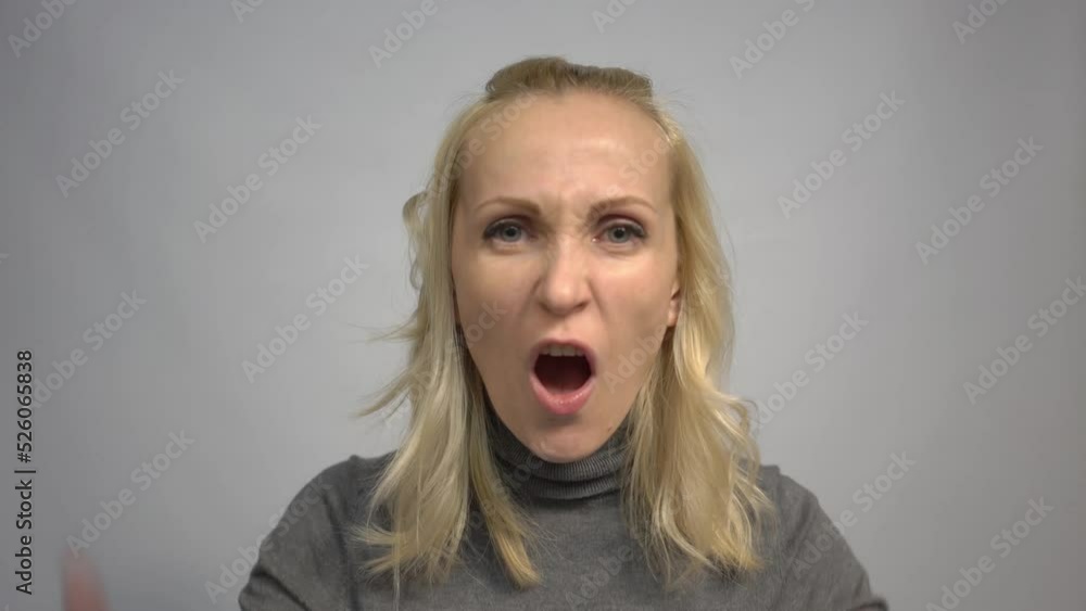 4k Angry woman screaming on gray background 4k Angry woman screaming on gray background