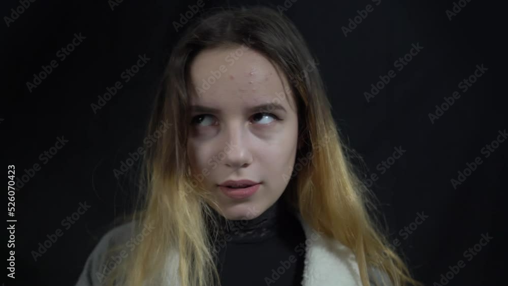 4k young woman makes face palm over black background 4k young woman makes face palm over black background