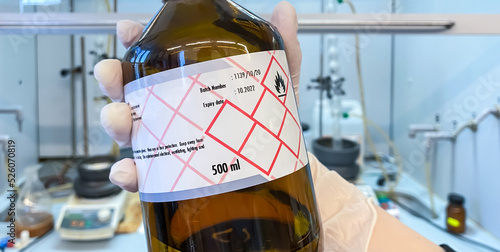 A bottle of an expired chemical reagent that should be properly disposed. Toxic chemical compounds and agents require special waste management systems.