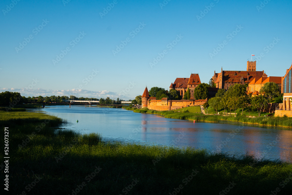 Marienburg Castle the largest medieval brick castle in the world in the city of Malbork at sunset