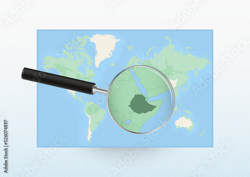 Map of the World with a magnifying glass aimed at Ethiopia, searching Ethiopia with loupe.