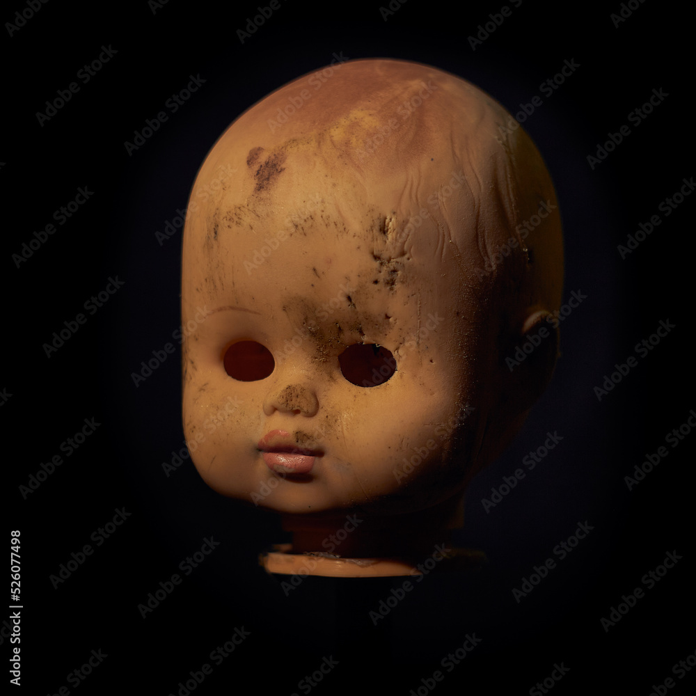 Damaged Dirty Doll head on black background Damaged Dirty Doll head on black background