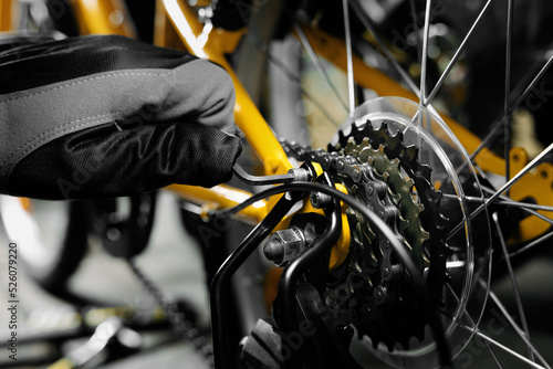bicycle maintenance and repair. mechanic working in bike service workshop. gear closeup