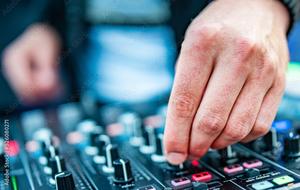 DJ Hands creating and regulating music on dj console mixer in concert outdoor DJ Hands creating and regulating music on dj console mixer in concert outdoor