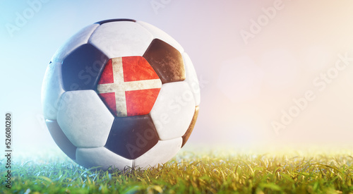 Football soccer ball with flag of Denmark on grass